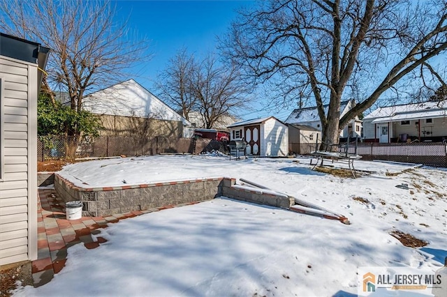 40 Brown Ave, Iselin, NJ 08830 - yard covered in snow with a storage shed, a patio area, and a residential view