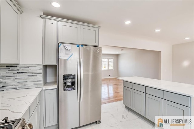 40 Brown Ave, Iselin, NJ 08830 - kitchen with stainless steel refrigerator with ice dispenser, gray cabinets, recessed lighting, light marble finish floors, and backsplash