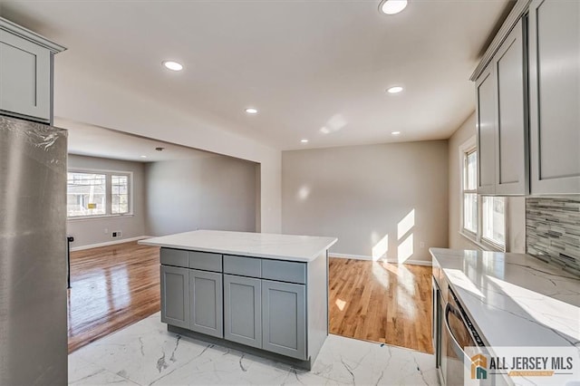 40 Brown Ave, Iselin, NJ 08830 - kitchen with gray cabinets, freestanding refrigerator, light marble finish floors, recessed lighting, and light stone counters