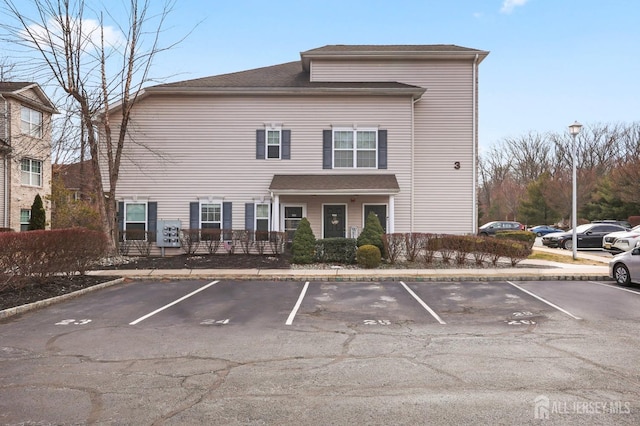 view of building exterior featuring uncovered parking