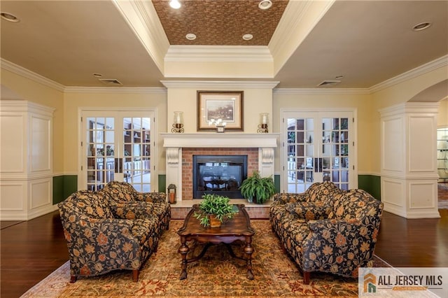 1410 Colts Cir, Lawrence, NJ 08648 - living room featuring french doors, dark wood finished floors, ornamental molding, a raised ceiling, and a fireplace