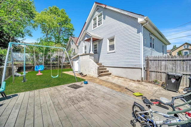 29 Pulawski Ave, South River, NJ 08882 - rear view of house with a playground, a fenced backyard, and a deck