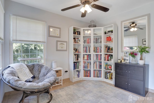 sitting room featuring ceiling fan