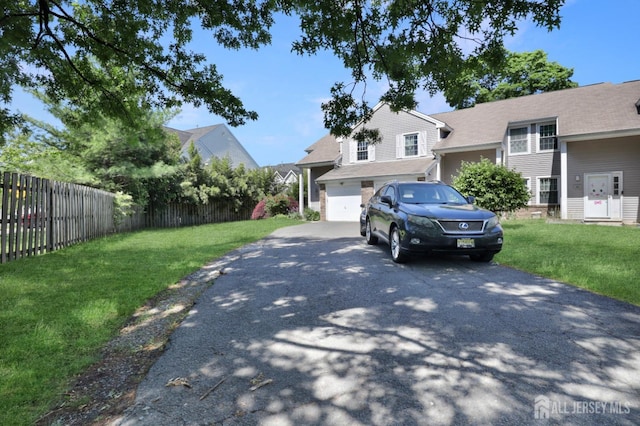 view of front facade with asphalt driveway and an attached garage