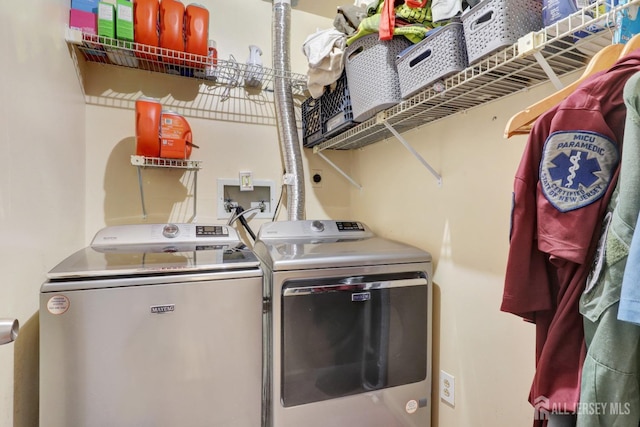 clothes washing area featuring washer and clothes dryer