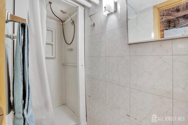 bathroom featuring a shower stall and ornamental molding