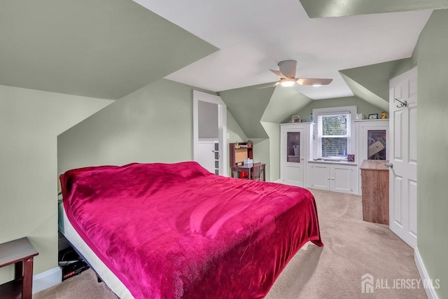 carpeted bedroom featuring vaulted ceiling and ceiling fan