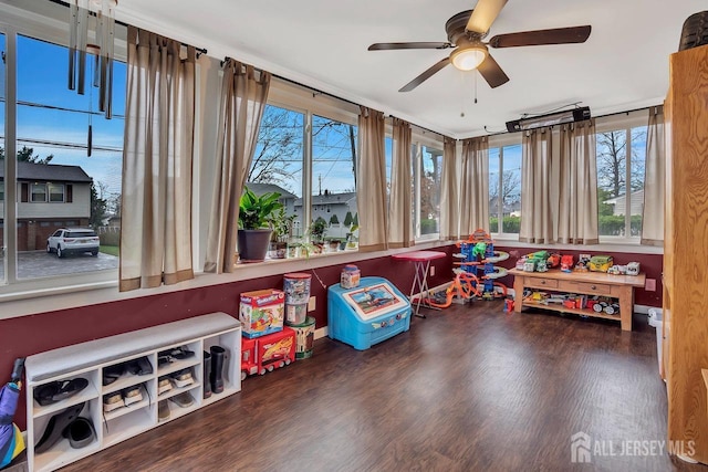 game room with healthy amount of natural light, ceiling fan, and wood finished floors