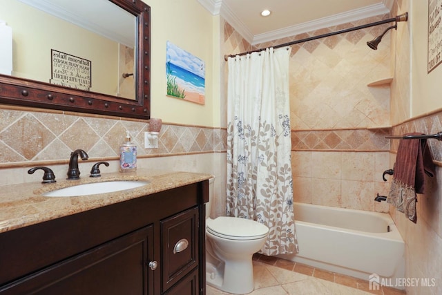 bathroom with tile walls, vanity, toilet, ornamental molding, and shower / bathtub combination with curtain