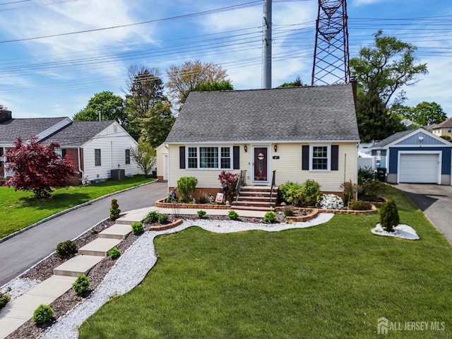 cape cod home with an outdoor structure, a front lawn, aphalt driveway, a shingled roof, and a detached garage