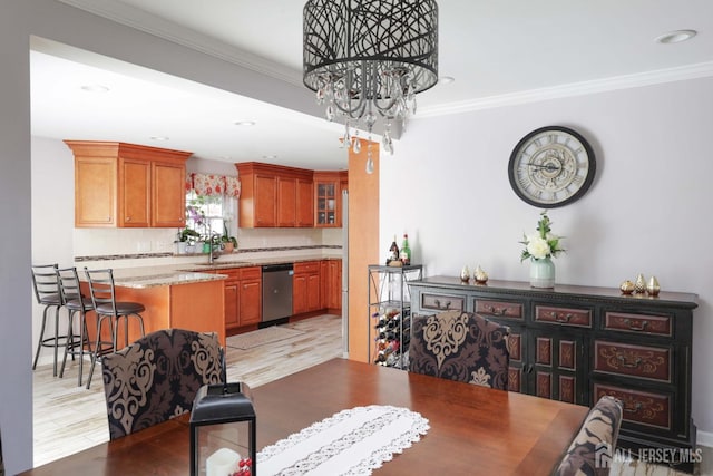 dining area featuring ornamental molding, recessed lighting, light wood-style flooring, and a notable chandelier