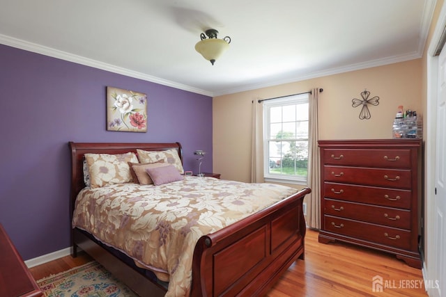 bedroom with crown molding, baseboards, and light wood-style floors