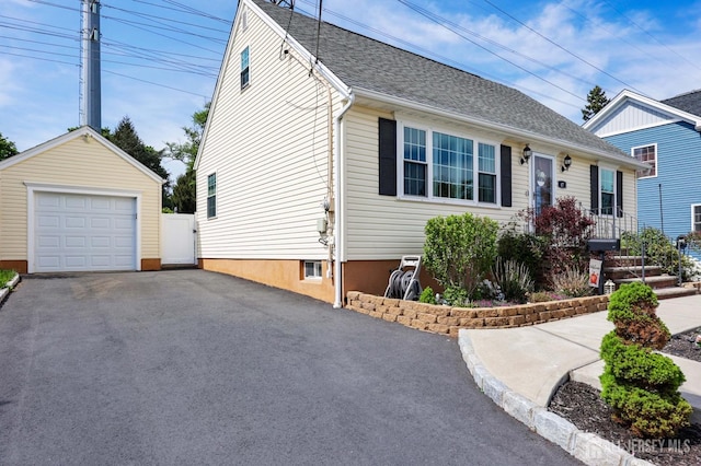 view of front of house with driveway, an outdoor structure, and a garage