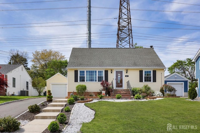cape cod home featuring a detached garage, central AC, an outbuilding, and a shingled roof