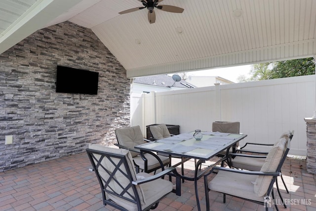 view of patio featuring fence, a ceiling fan, and outdoor dining area