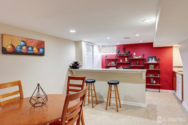 interior space with indoor bar, recessed lighting, baseboards, and visible vents