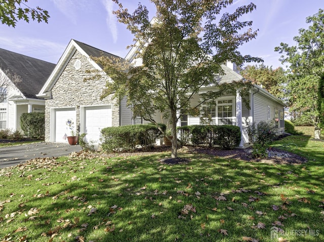 view of front of house featuring a garage and a front lawn