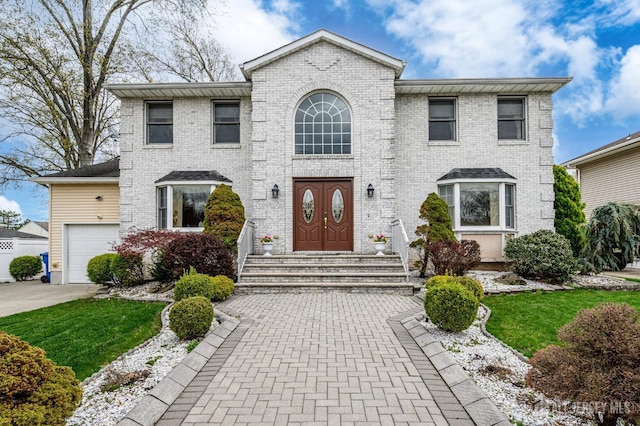 view of front facade with brick siding, a garage, and concrete driveway