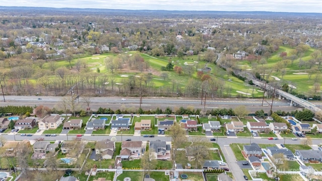 aerial overview of property's location with nearby suburban area and a golf course