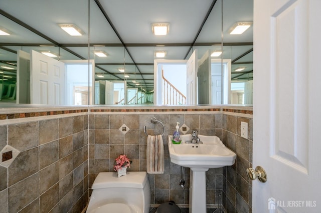 bathroom with tile walls