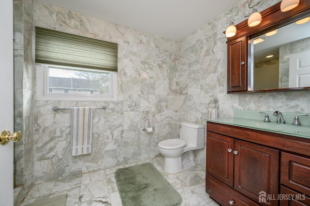 full bathroom with toilet, vanity, a shower, marble finish floors, and tile walls