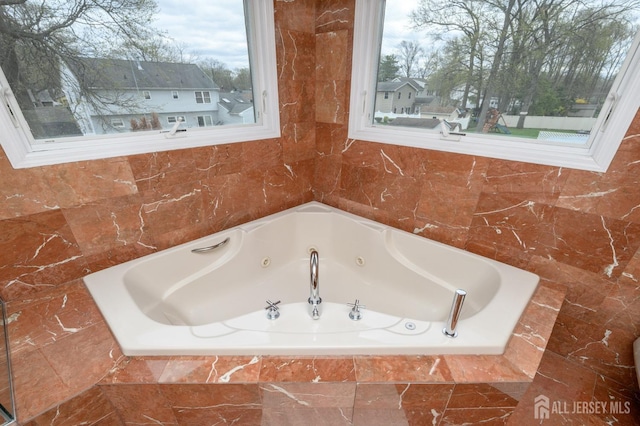 bathroom with a tub with jets