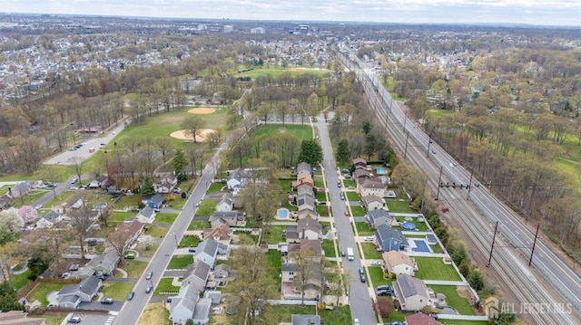 aerial view of property and surrounding area featuring nearby suburban area and a highway
