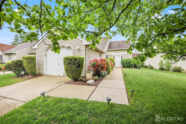 639 Madison Dr Unit C, Monroe, NJ 08831 - view of home's exterior featuring driveway, a yard, an attached garage, and a shingled roof