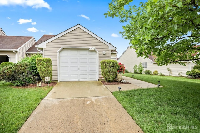 639 Madison Dr Unit C, Monroe, NJ 08831 - view of front of home with a front lawn, driveway, an outbuilding, and a detached garage