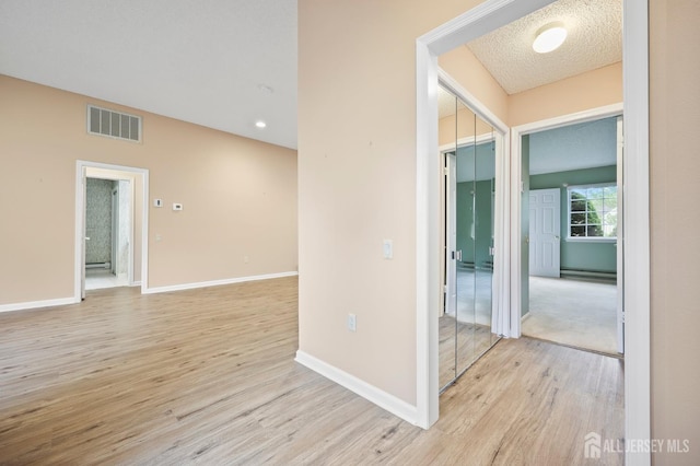639 Madison Dr Unit C, Monroe, NJ 08831 - hallway with light wood-style floors, baseboards, and a baseboard heating unit