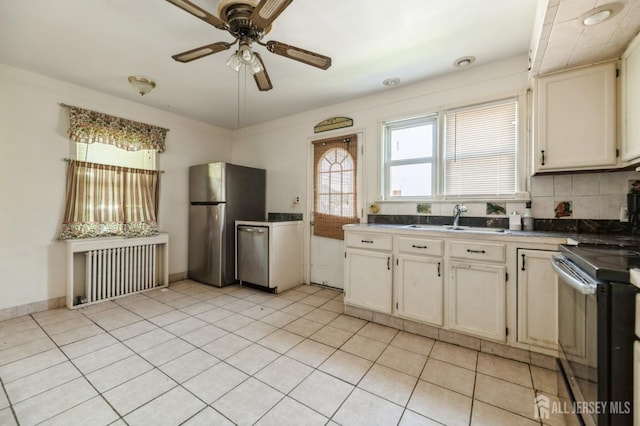 17 New Brunswick Ave, Matawan, NJ 07747 - kitchen with stainless steel appliances, radiator, a ceiling fan, light tile patterned floors, and backsplash
