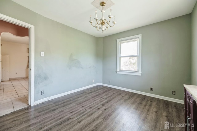 17 New Brunswick Ave, Matawan, NJ 07747 - spare room featuring a chandelier, wood finished floors, and arched walkways