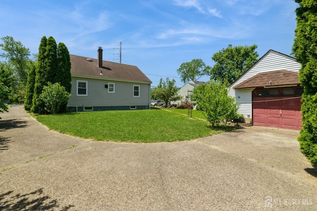 17 New Brunswick Ave, Matawan, NJ 07747 - view of side of property with a lawn, concrete driveway, an outdoor structure, a chimney, and a garage