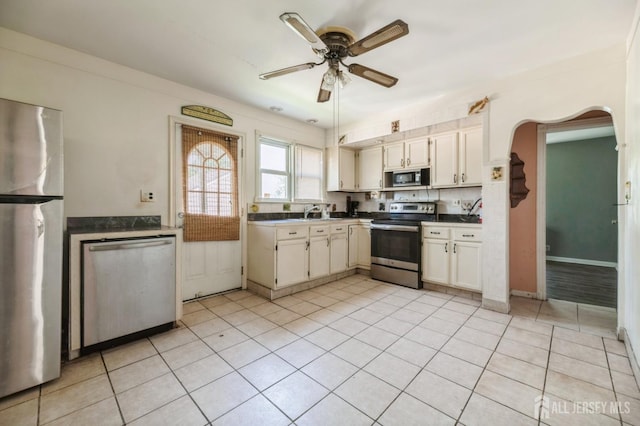 17 New Brunswick Ave, Matawan, NJ 07747 - kitchen featuring stainless steel appliances, a ceiling fan, arched walkways, and light tile patterned floors