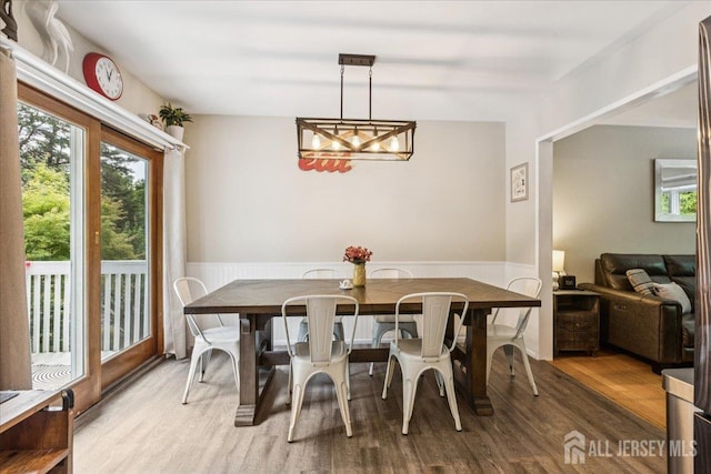 383 S Stump Tavern Rd S, Jackson, NJ 08527 - dining space featuring wood finished floors, a wainscoted wall, and a chandelier