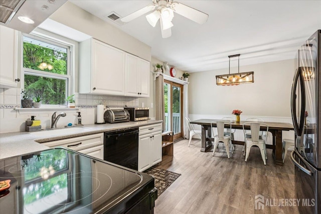 383 S Stump Tavern Rd S, Jackson, NJ 08527 - kitchen featuring black appliances, white cabinets, decorative backsplash, and light countertops