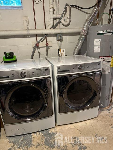 383 S Stump Tavern Rd S, Jackson, NJ 08527 - laundry room with water heater, concrete block wall, and washing machine and dryer