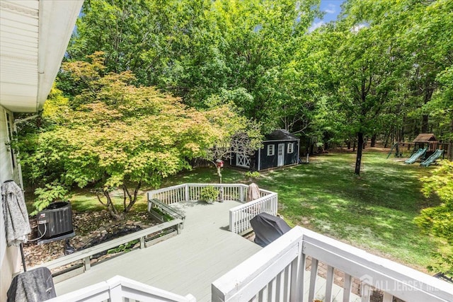 383 S Stump Tavern Rd S, Jackson, NJ 08527 - deck with a lawn, an outbuilding, a playground, and view of wooded area