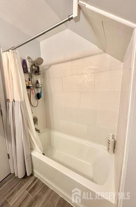 383 S Stump Tavern Rd S, Jackson, NJ 08527 - bathroom with shower / bathtub combination with curtain and wood finished floors