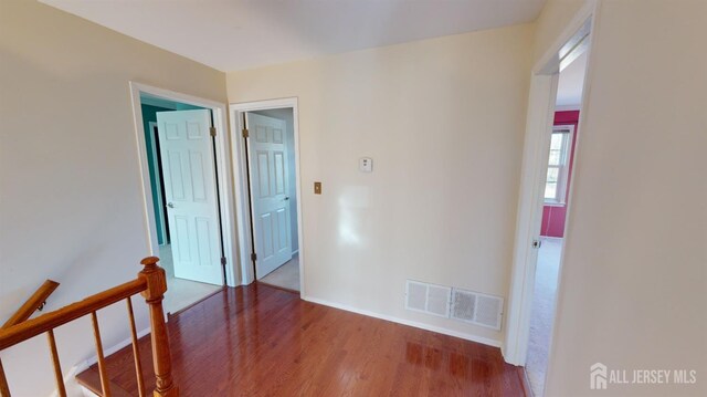 hallway with hardwood / wood-style floors