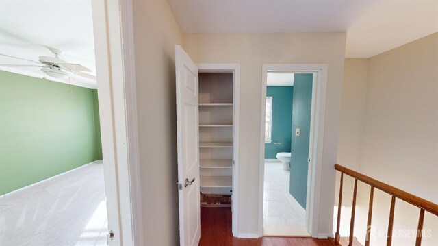 corridor with hardwood / wood-style floors