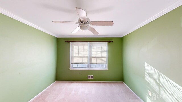 unfurnished room featuring ceiling fan, crown molding, and light carpet