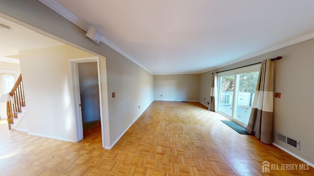 spare room featuring ornamental molding and light parquet flooring