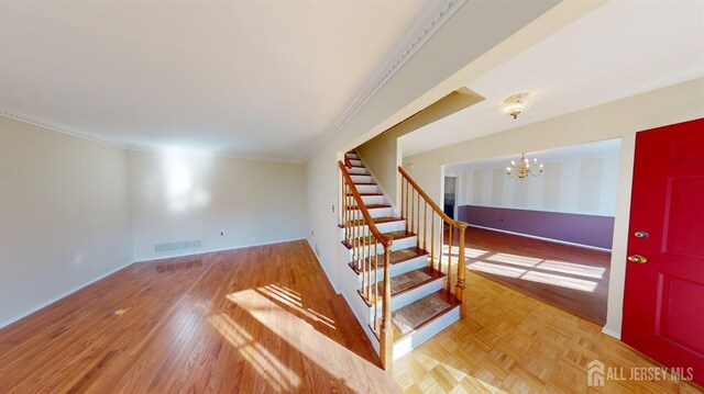 interior space with ornamental molding and a notable chandelier