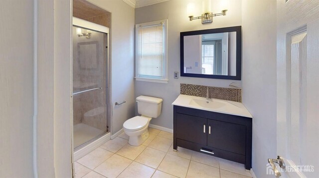 bathroom with toilet, crown molding, tile patterned floors, vanity, and a shower with door