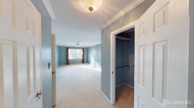 hall featuring ornamental molding and light carpet