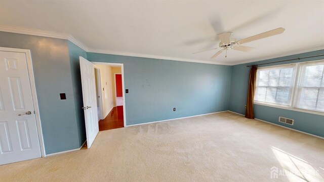 interior space with ceiling fan and crown molding