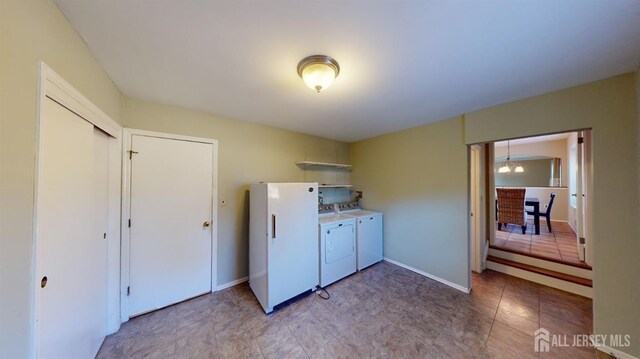 clothes washing area featuring washer and clothes dryer