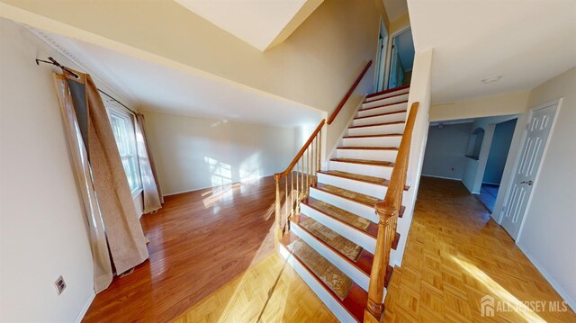 staircase featuring wood-type flooring