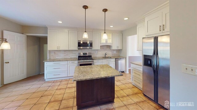 kitchen featuring a kitchen island, stainless steel appliances, and white cabinets